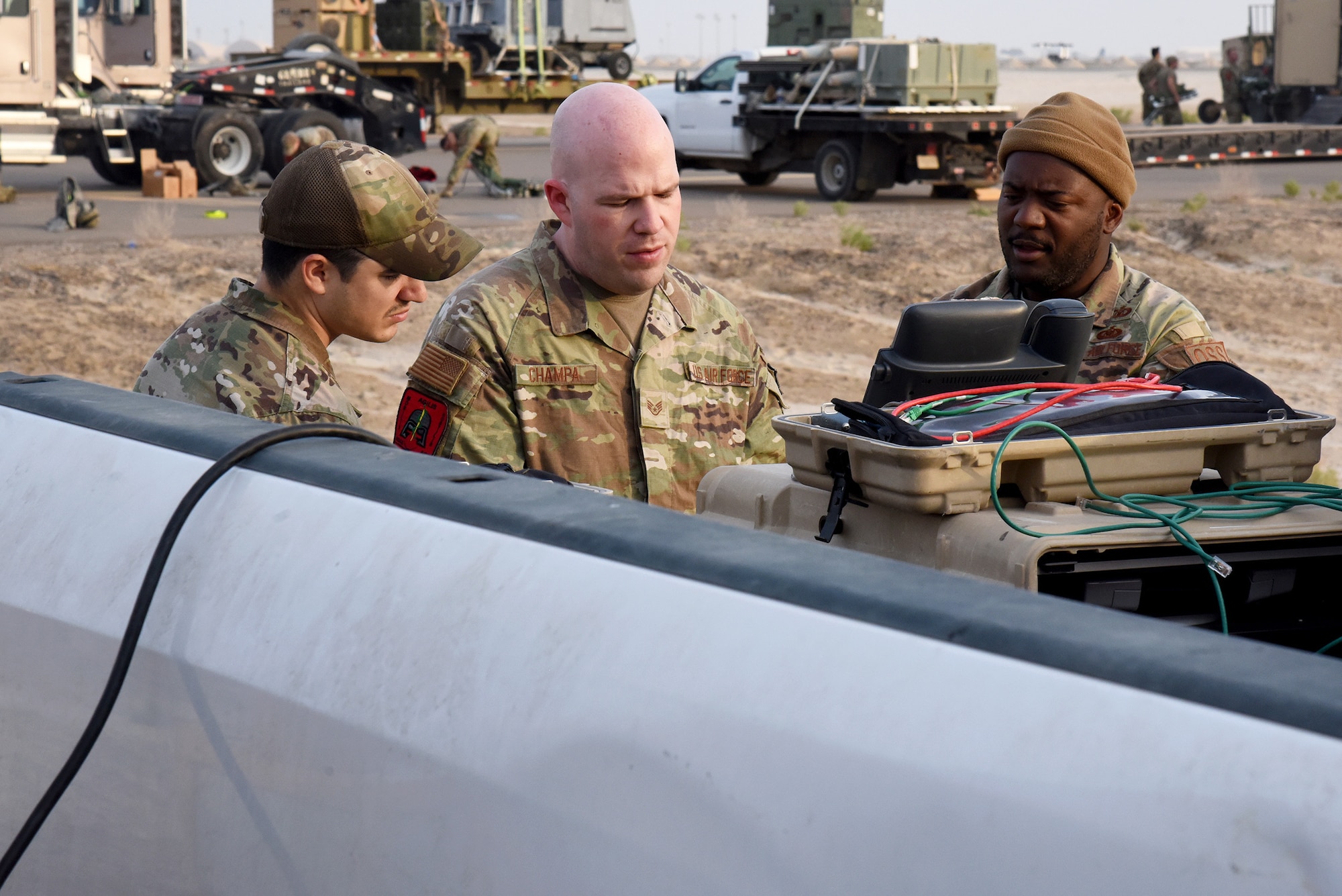 U.S. Air Force Staff Sgt. Edward Champa (center), Senior Airman Drake Conrad (left), 380th Multi-Capable Airman Team 1 members, and Lt. Col. Tony Bridgewater, Agile Combat Employment project officer, prepare to disassemble communication gear during Operation Agile Spartan 4 at Al Dhafra Air Base, United Arab Emirates, March 10, 2023. Operation Agile Spartan is a Multi-Capable Airman and Agile Combat Employment exercise that takes place across the U.S. Central Command area of responsibility. (U.S. Air Force photo by Tech. Sgt. Chris Jacobs/released)