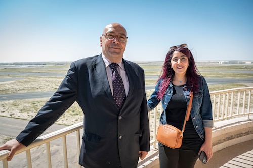 Mr. Osama Diab and Ms. Mai Alsoukari, Kuwaiti newspaper journalists, pose for a photo outside the air traffic control tower during Media Day at Ali Al Salem Air Base, Kuwait, March 21, 2023.