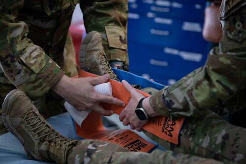Medical professionals from the 386th Expeditionary Medical Squadron show Kuwaiti newspaper journalists how to use a splint during Media Day at Ali Al Salem Air Base, Kuwait, March 21, 2023.