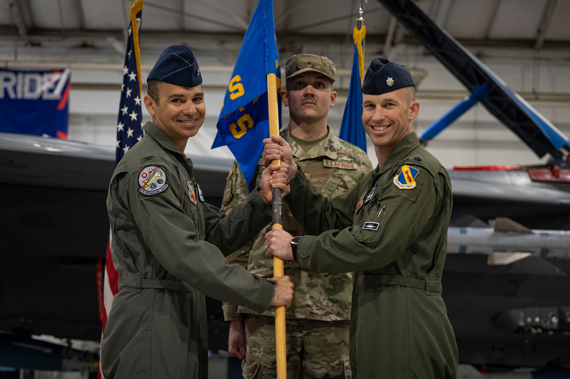 Col. Michael Alfaro, left, 4th Operations Group commander, passes the 4th Training Squadron gudion to Lt. Col. Tanner Hein, 4th TS commander, during the 4th TS Change of Command Ceremony at Seymour Johnson Air Force Base, North Carolina, March 17, 2023. The passing of the guidon to a new commander symbolizes the acceptance of command.