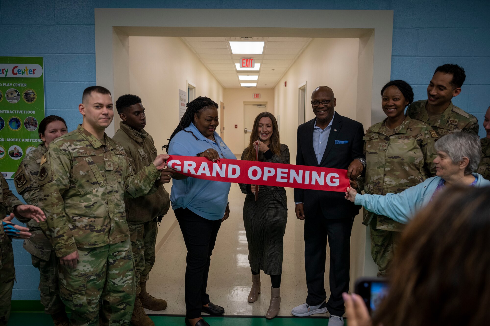 Airmen assigned to the 4th Fighter Wing cut a ribbon during the Discovery Center Ribbon Cutting Ceremony at Seymour Johnson Air Force Base, North Carolina, March 23, 2023. Interactive play stations in the Discovery Center include a farmers’ market, a teddy bear medical clinic and a science station.