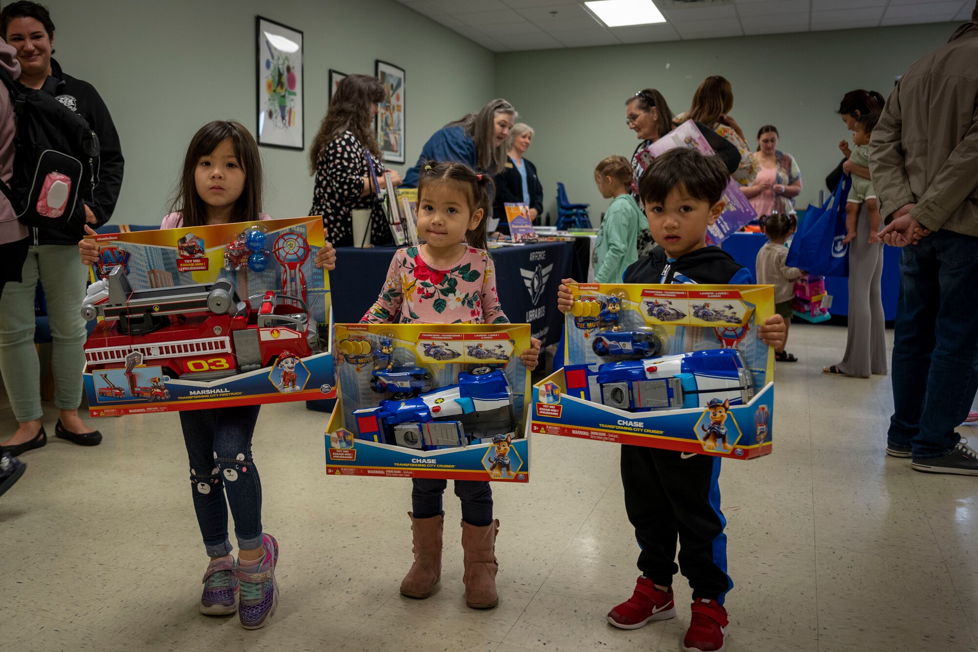 Children of 4th Fighter Wing Airmen show off toys during the Discovery Center Ribbon Cutting Ceremony at Seymour Johnson Air Force Base, North Carolina, March 23, 2023. The North Carolina USO donated toys for children to take after the ceremony.