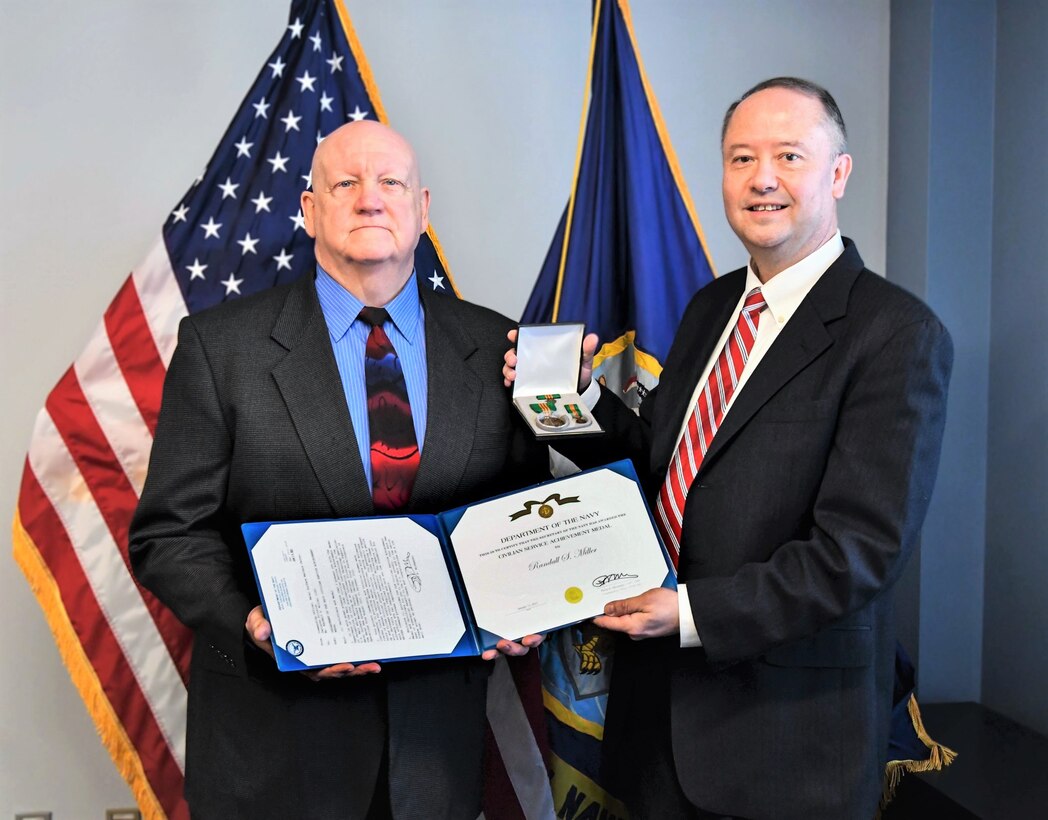 IMAGE: Randall Miller (left) is presented the Department of the Navy Civilian Service Achievement Medal, March 15.