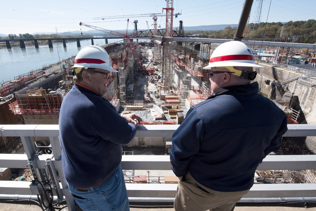 Kevin Jasper (Right), U.S. Army Corps of Engineers Nashville District’s Integrated Project Office interim chief, talks with Doug Underwood, Erwin Marine Sales, Inc., while overlooking ongoing construction March 20, 2023, of a navigation lock chamber. The Nashville District is building a larger navigation lock at Chickamauga Lock on the Tennessee River in Chattanooga, Tennessee. Underwood took part in a roundtable and project tour at the invitation of the Corps of Engineers. (USACE Photo by Lee Roberts)