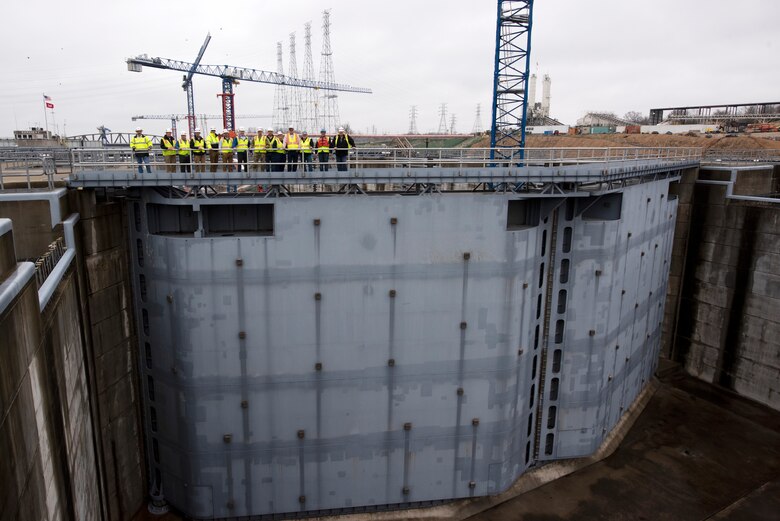 U.S. Army Corps of Engineers Nashville District officials and stakeholders pose for a group photo on top of the miter gates of the completed upstream lock chamber during a tour of the active Kentucky Lock and Kentucky Lock Addition Project on the Tennessee River in Grand Rivers, Kentucky. The Nashville District engaged with stakeholders March 22, 2023, to provide an update on the important navigation project and to promote partnerships and communication. (USACE Photo by Lee Roberts)