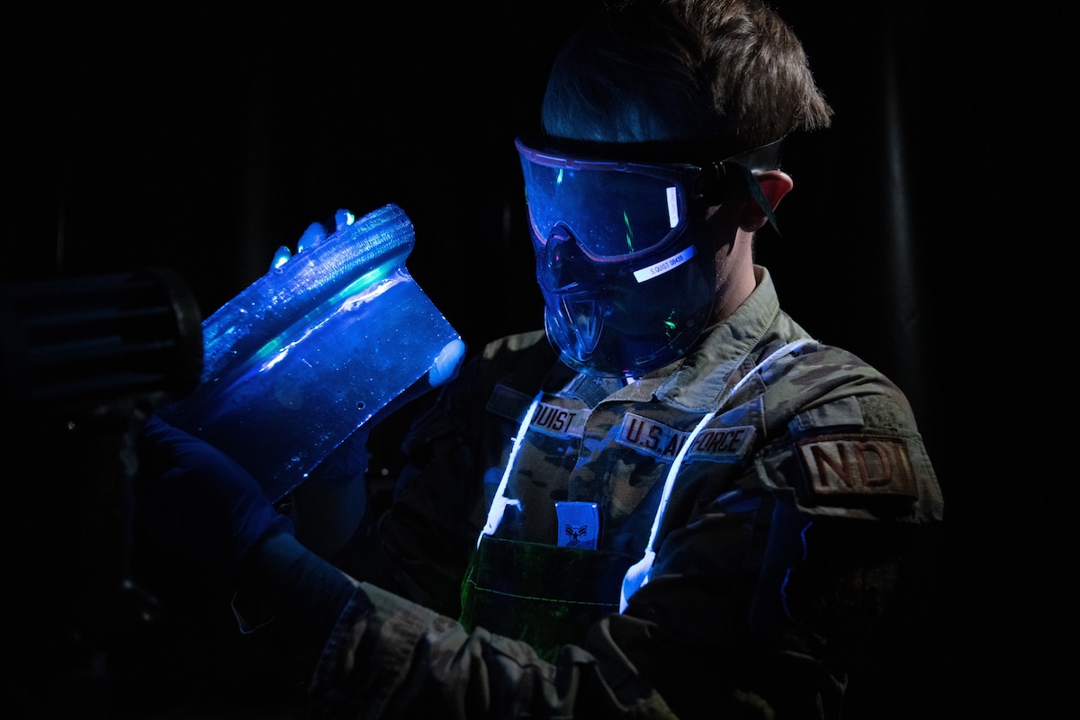 Airman 1st Class. Seth Quist, a non-destructive inspector with the 349 Maintenance Squadron,  checks for cracks and hairline fractures ultraviolet light, March 8, 2023.