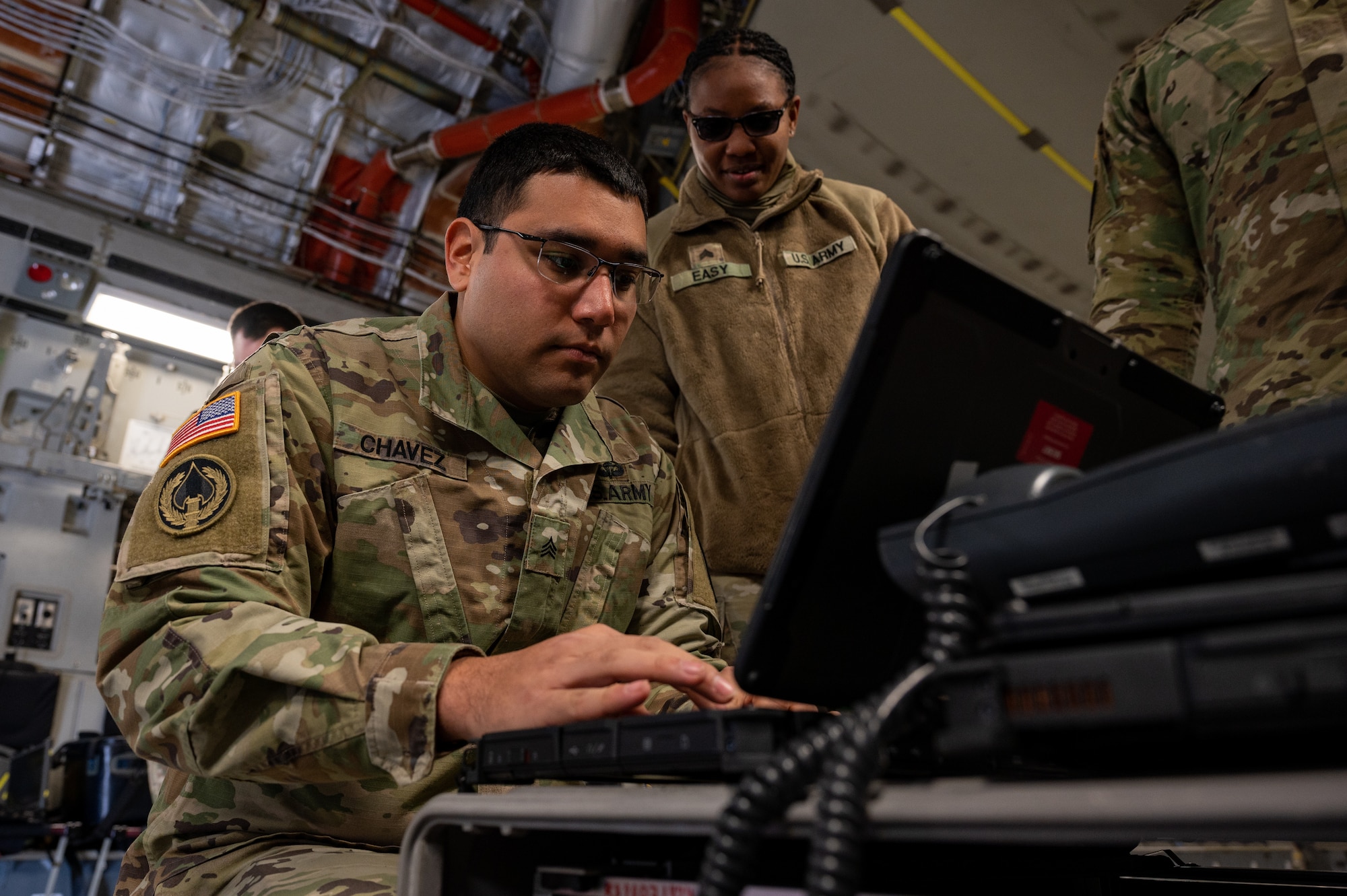 U.S Army Sgt. Ryan Chavez, left, and Sgt. Monique Easy, Joint Communications Support Element Soldiers, MacDill Air Force Base, Florida, work on setting up the Command and Control Element during Black Flag 23-1 at Nellis Air Force Base, Nevada, Feb. 23, 2023. Airmen and Soldiers executed mission sets that demonstrated the ability to provide integral communication through accessing Department of Defense computer networks, employing multiple tactical data links, and communicating with aircraft. (U.S. Air Force photo by Airman 1st Class Josey Blades)