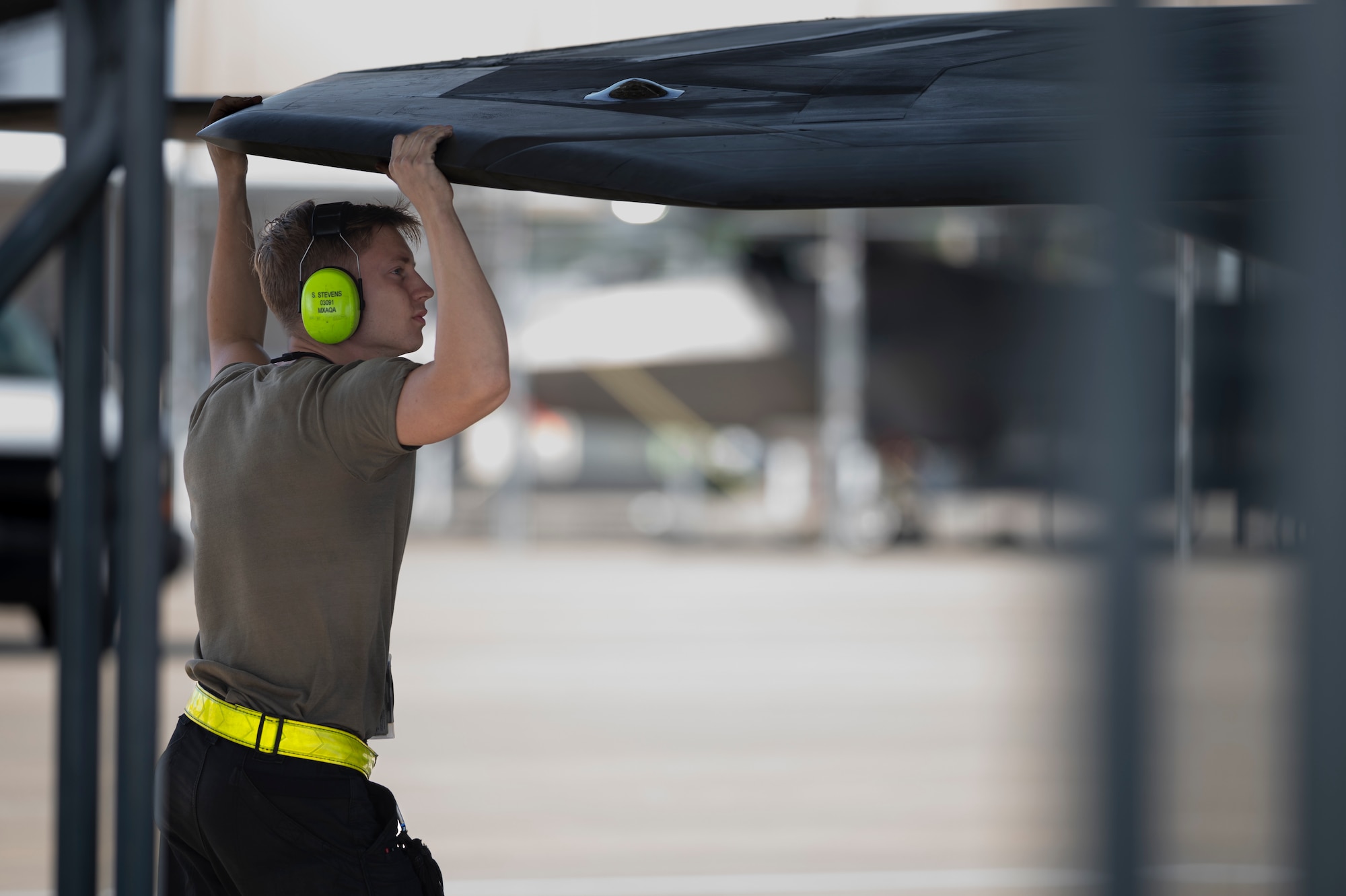 Crew chief inspects the wing of an aircraft