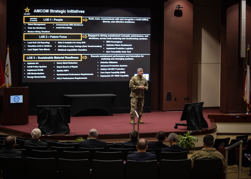 Commanding general on stage at conference.