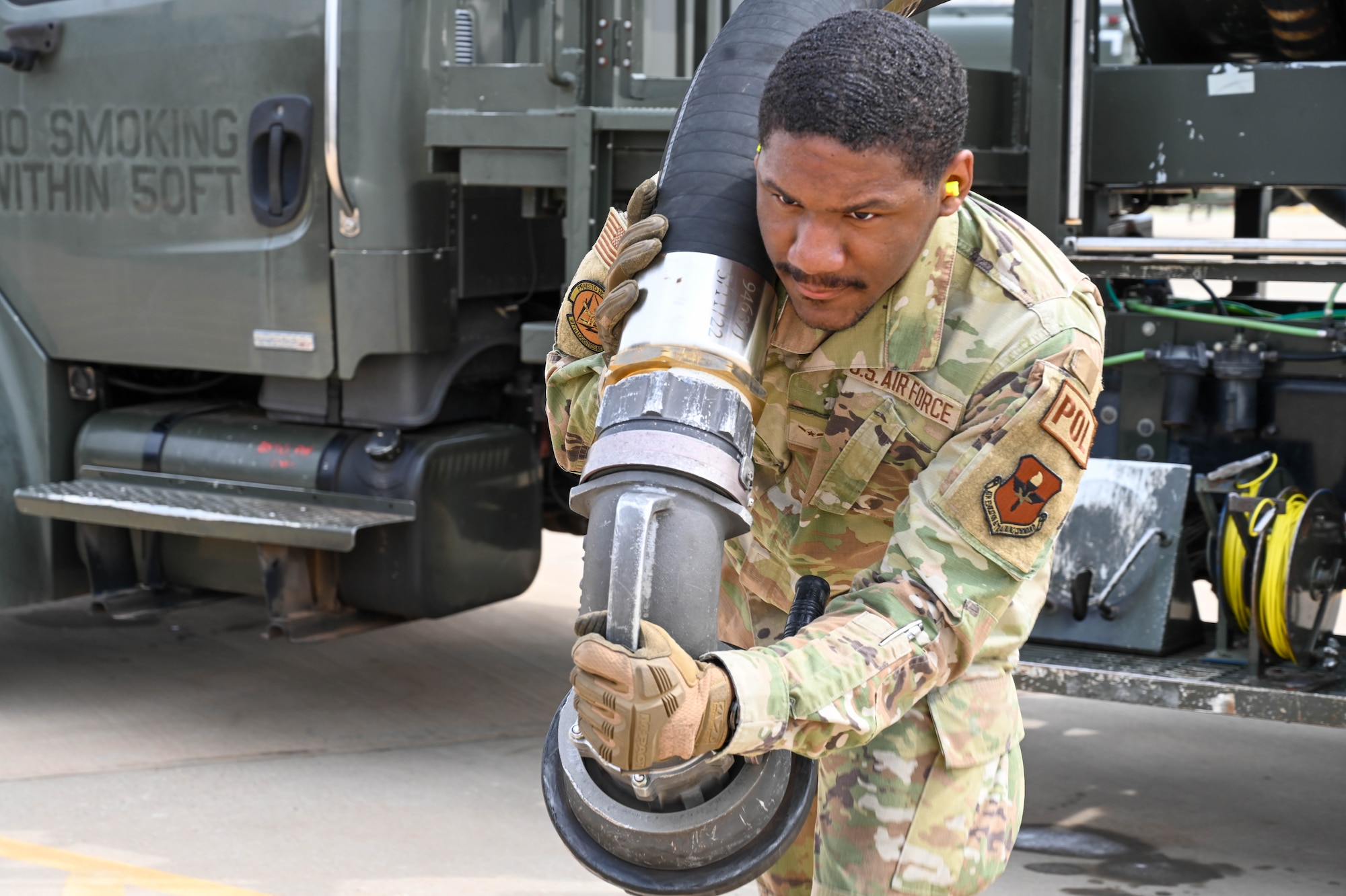 U.S. Air Force Airman Caleb Sells, 97th Logistics Readiness Squadron fuels distribution technician, pulls out a moose head hose to hook into a hydrant’s outlet at Altus Air Force Base (AFB), Oklahoma, March 23, 2023. The Altus AFB fuels management flight distributes more than 44 million gallons of fuel per year, the highest number in Air Education and Training Command and the ninth-highest number in the Department of Defense. (U.S. Air Force photo by Senior Airman Trenton Jancze)