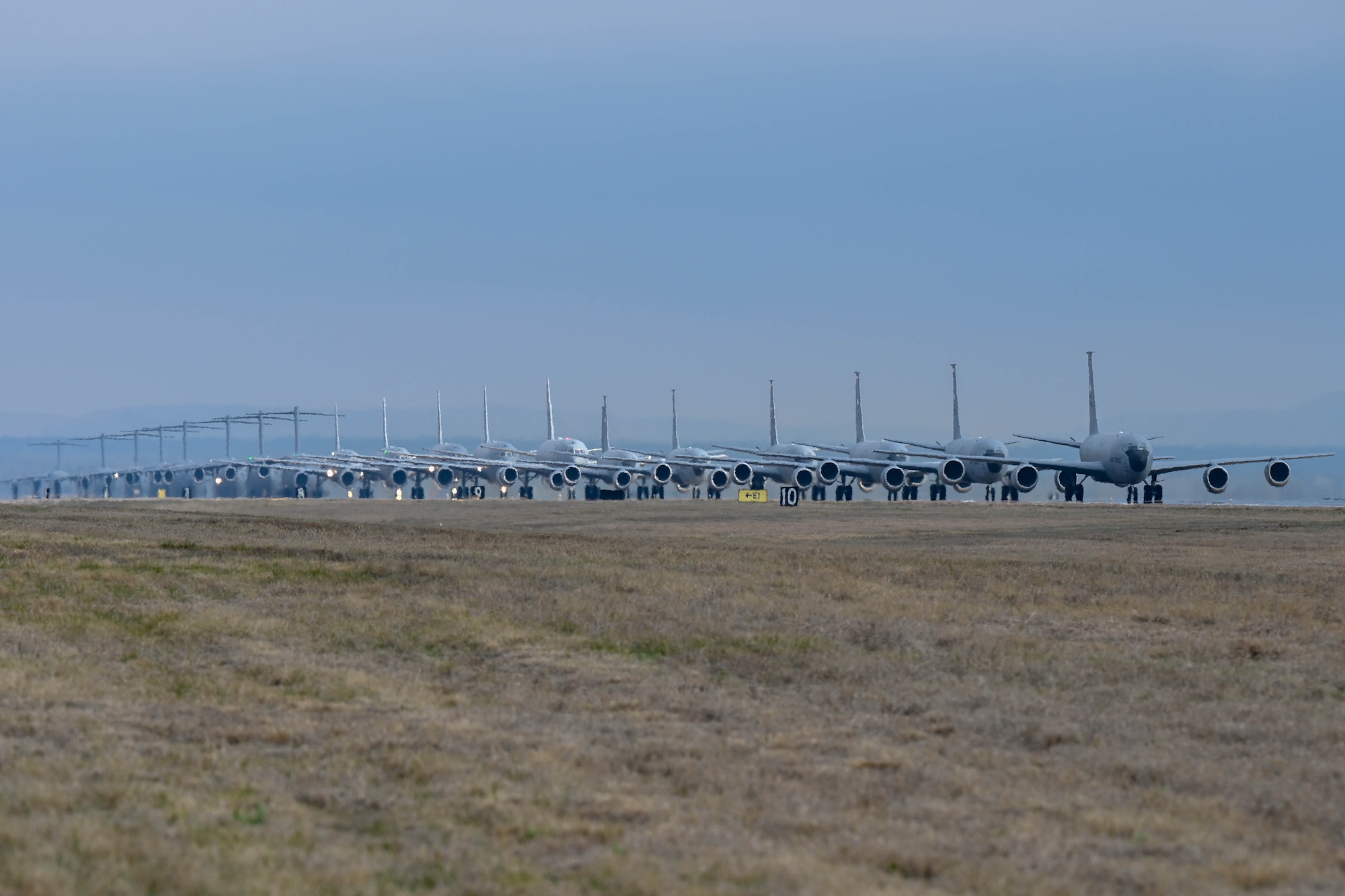 KC-135 Stratotankers, C-17 Globemaster IIIs and KC-46 Pegasus aircraft line up for an “elephant walk” at Altus Air Force Base, Oklahoma, during a large force exercise, March 24, 2023. The exercise simulated a mass evacuation of aircraft in preparation for severe weather emergencies. (U.S. Air Force photo by Senior Airman Trenton Jancze)