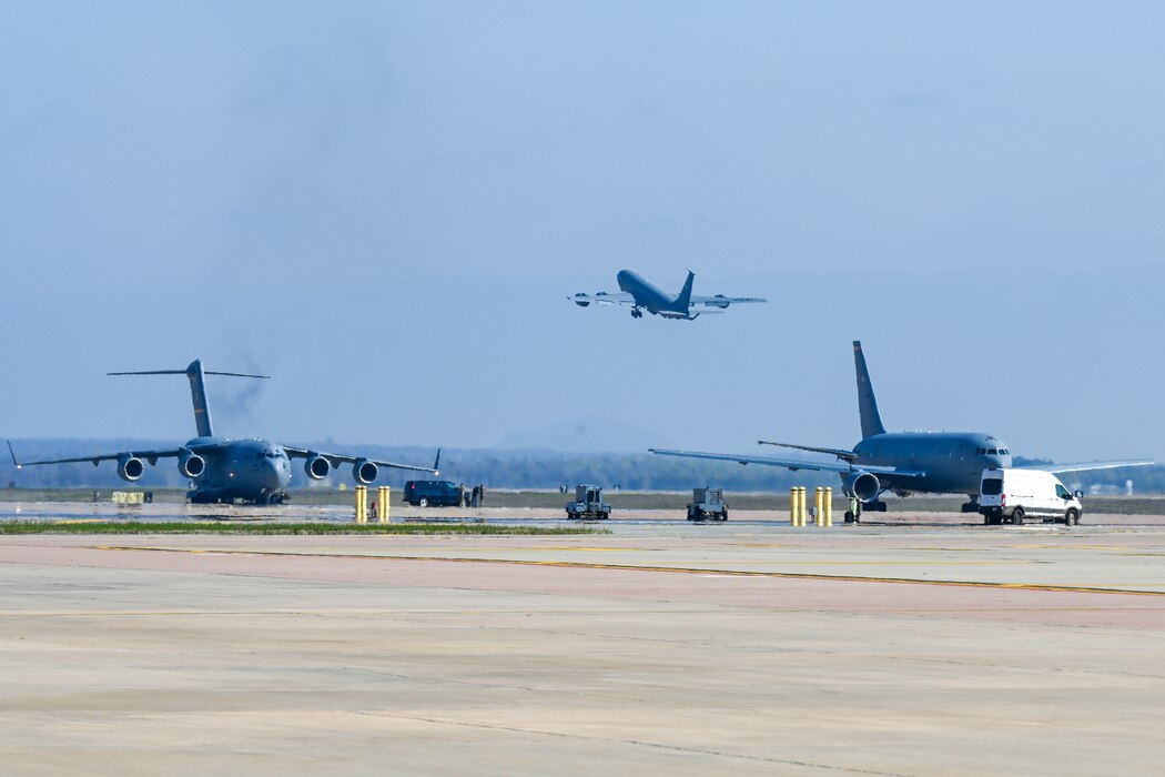 Aircraft taxi and take off on the Altus Air Force Base, Oklahoma, flightline, March 24, 2022, during a large force exercise. KC-135 Stratotankers, C-17 Globemaster IIIs, and KC-46 Pegasus aircraft made up the 20-aircraft fleet that launched during the exercise. (U.S. Air Force photo by Senior Airman Trenton Jancze)