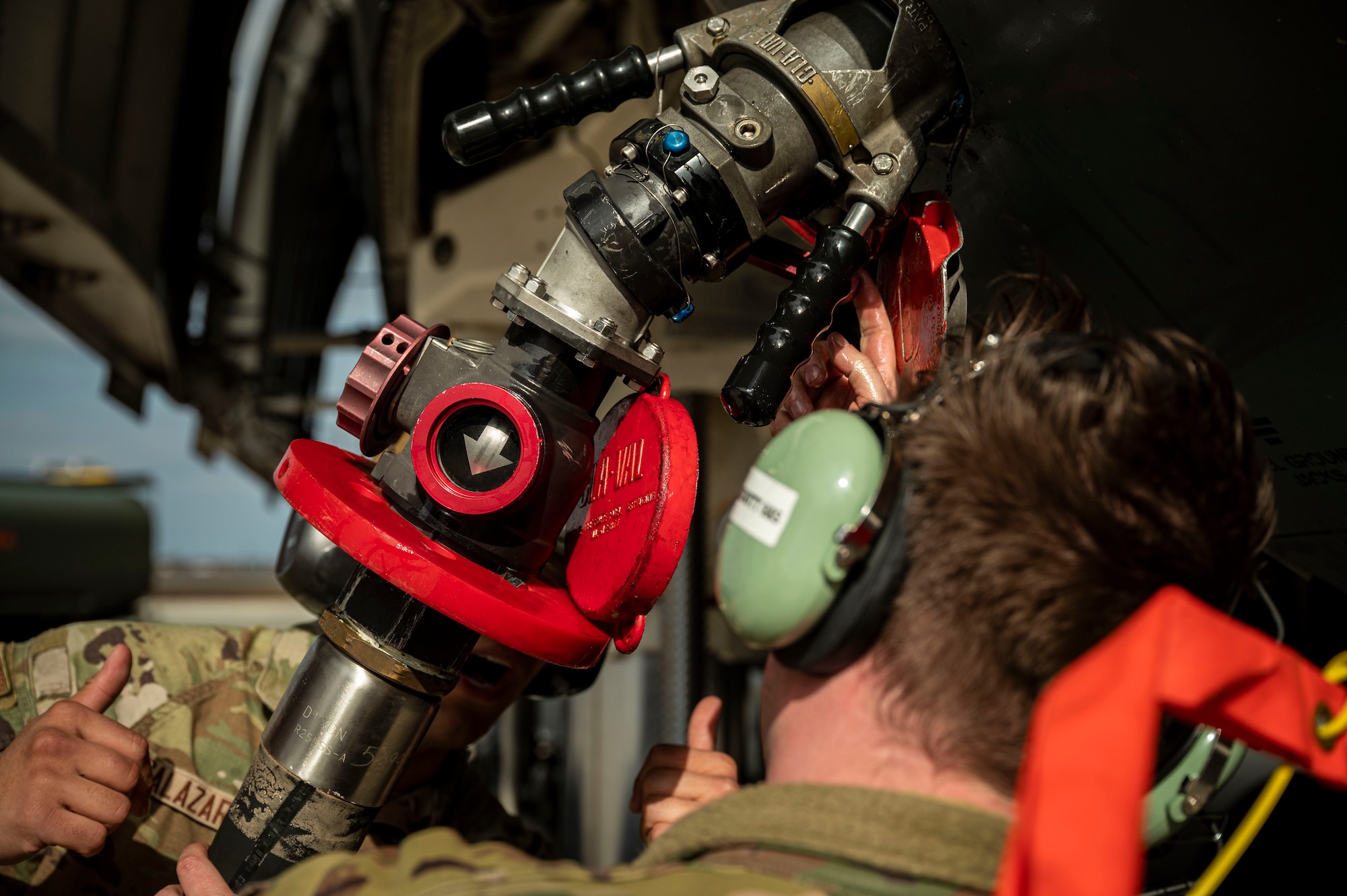 Staff Sgt. Kyle Hewitt, right, 9th Airlift Squadron flight engineer, and Airman 1st Class Casey Salazar, left, 436th Logistics Readiness Squadron fuels distribution operator, secure a fuel hose from an R-11 Refueler onto a C-5M Super Galaxy during a wet wing defuel at Dover Air Force Base, Delaware, March 1, 2023. Aircrew with the 9th AS test out new capabilities that allow the C-5 to act as a mobile fuel station and deposit fuel from the aircraft fuel tanks, into tankers standing by. (U.S. Air Force photo by Staff Sgt. Marco A. Gomez)