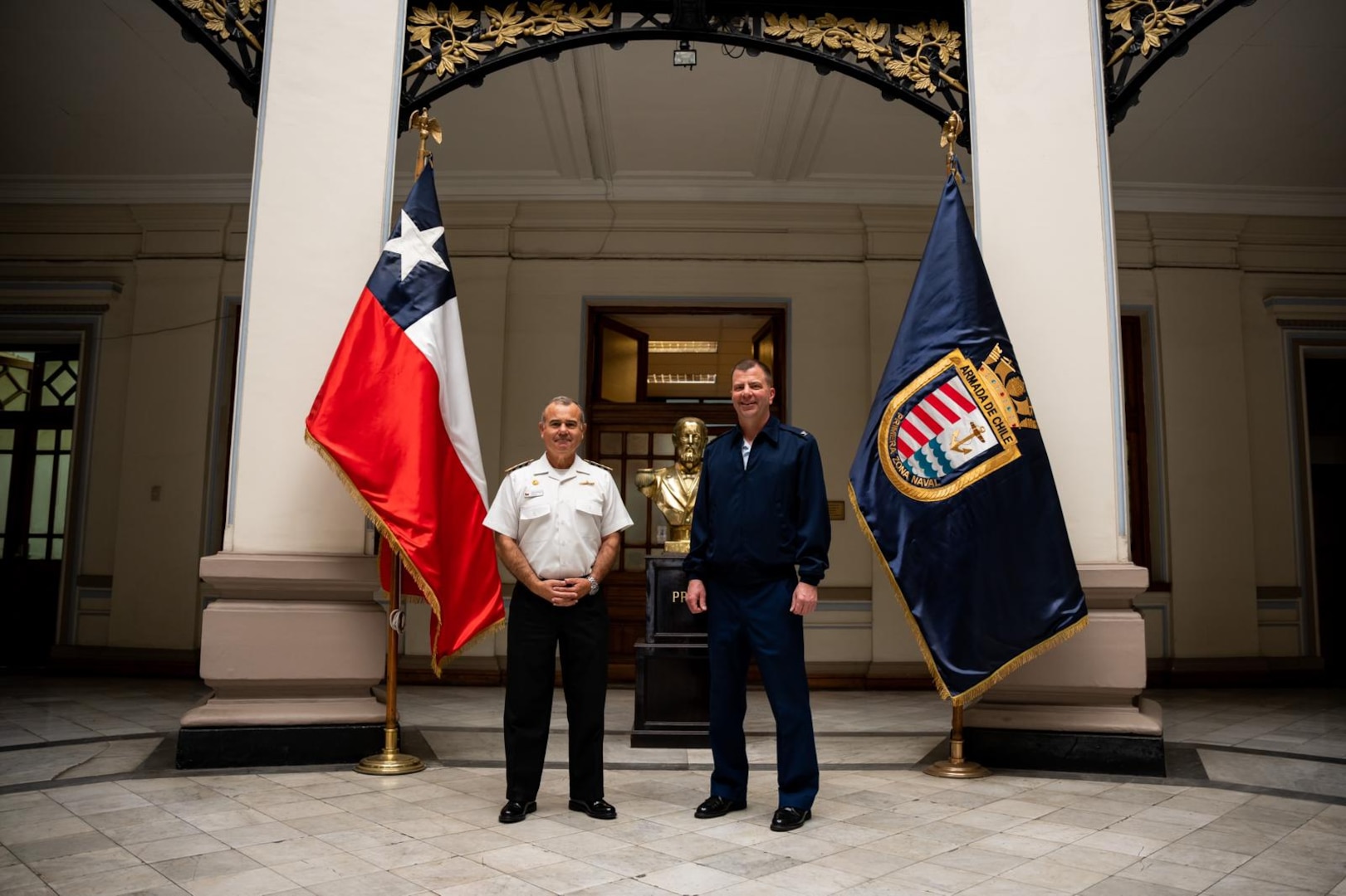 Chilean Navy Rear Adm. Juan Zúñiga, Commander of the First Naval Zone, and U.S. Coast Guard Capt. Keith Ropella, commanding officer of Coast Guard Cutter Polar Star (WAGB 10) pose for a photo in the Headquarters of the First Naval Zone, Valparaíso, Chile, March 20, 2023. Chile has been a reliable partner in supporting the annual Operation Deep Freeze mission, which is emblematic of the deep and enduring military and scientific collaboration between the U.S. and Chile. (U.S. Coast Guard photo by Petty Officer 3rd Class Aidan Cooney)