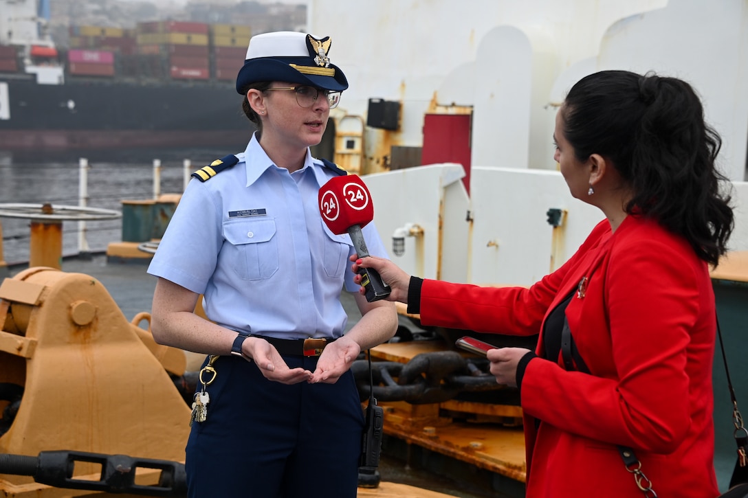 U.S. Coast Guard Lt. Lauren Kowalski, assistant operations officer aboard U.S. Coast Guard Cutter Polar Star (WAGB 10) provides information to a Chilean media member aboard the Polar Star in Valparaiso, Chile, March 21, 2023. This is the first time since 2016 the Polar Star has made a port call in Valparaiso. (U.S. Coast Guard photo by Senior Chief Petty Officer Charly Tautfest)