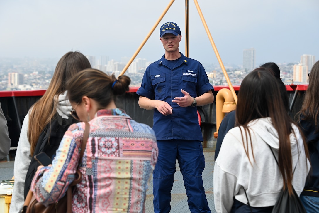 U.S. Coast Guard Chief Warrant Officer John Skinner, U.S. Coast Guard Cutter Polar Starr (WAGB 10) crewmember, talks with youth from the Instituto Chileno Norteamericano de Cultura Valparaíso, aboard the Polar Star in Valparaiso, Chile, March 21, 2023. The youth came aboard for tours to talk with the crew about the recent Operation Deep Freeze 2023 mission and learn about ice breaking operations. (U.S. Coast Guard photo by Senior Chief Petty Officer Charly Tautfest)