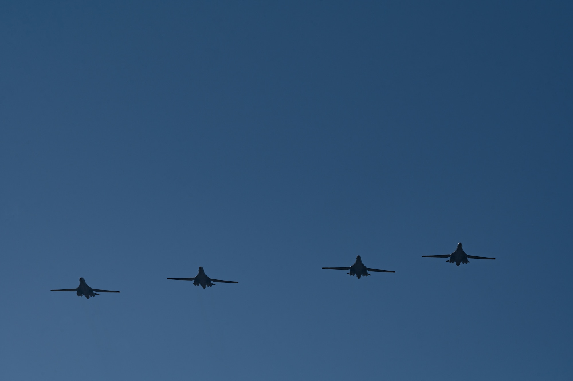 B-1B Lancers fly over the flightline at Dyess Air Force Base, Texas, March 24, 2023. Seven B-1s returned to Dyess after being relocated to Holloman AFB, New Mexico, due to possible major storms. The short-notice aircraft relocation demonstrated the agility of 7th Bomb Wing Airmen while confirming Dyess Strikers are ready to implement agile combat employment on a moment's notice. (U.S. Air Force photo by Airman Emma Anderson)