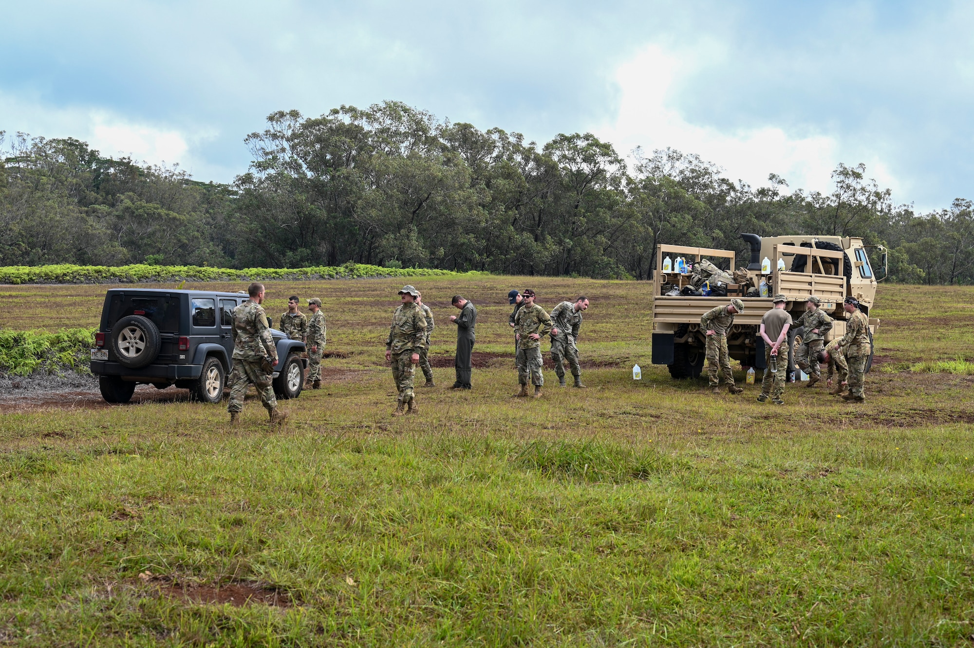 U.S. Air Force members from Fairchild Air Force Base, Washington, get ready to explore the jungle during a simulated isolation scenario near Bellows Air Force Station, Hawaii, Feb. 2, 2023. Members from Team Fairchild’s innovation cell conducted an event to review current foundational survival training methods and their applicability to tropic, jungle, and coastal conditions. (U.S. Air Force photo by Airman 1st Class Haiden Morris)