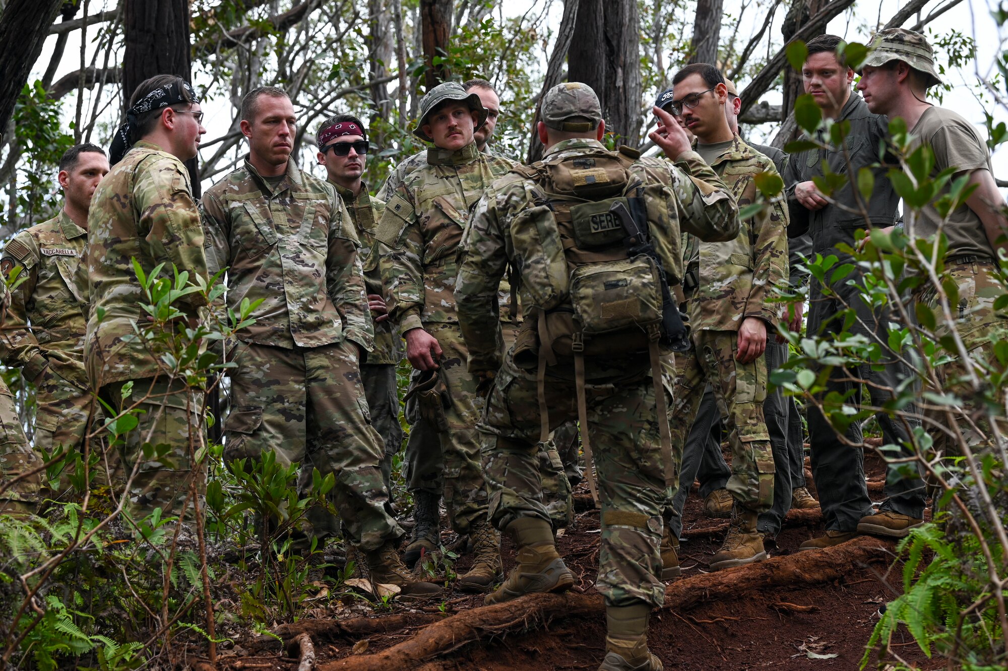 U.S. Air Force members from Fairchild Air Force Base, Washington, are briefed on survival techniques in the jungle during a simulated isolation scenario near Bellows Air Force Station, Hawaii, Feb. 2, 2023. Members from Team Fairchild’s innovation cell conducted an event to review current foundational survival training methods and their applicability to tropic, jungle, and coastal conditions. (U.S. Air Force photo by Airman 1st Class Haiden Morris)