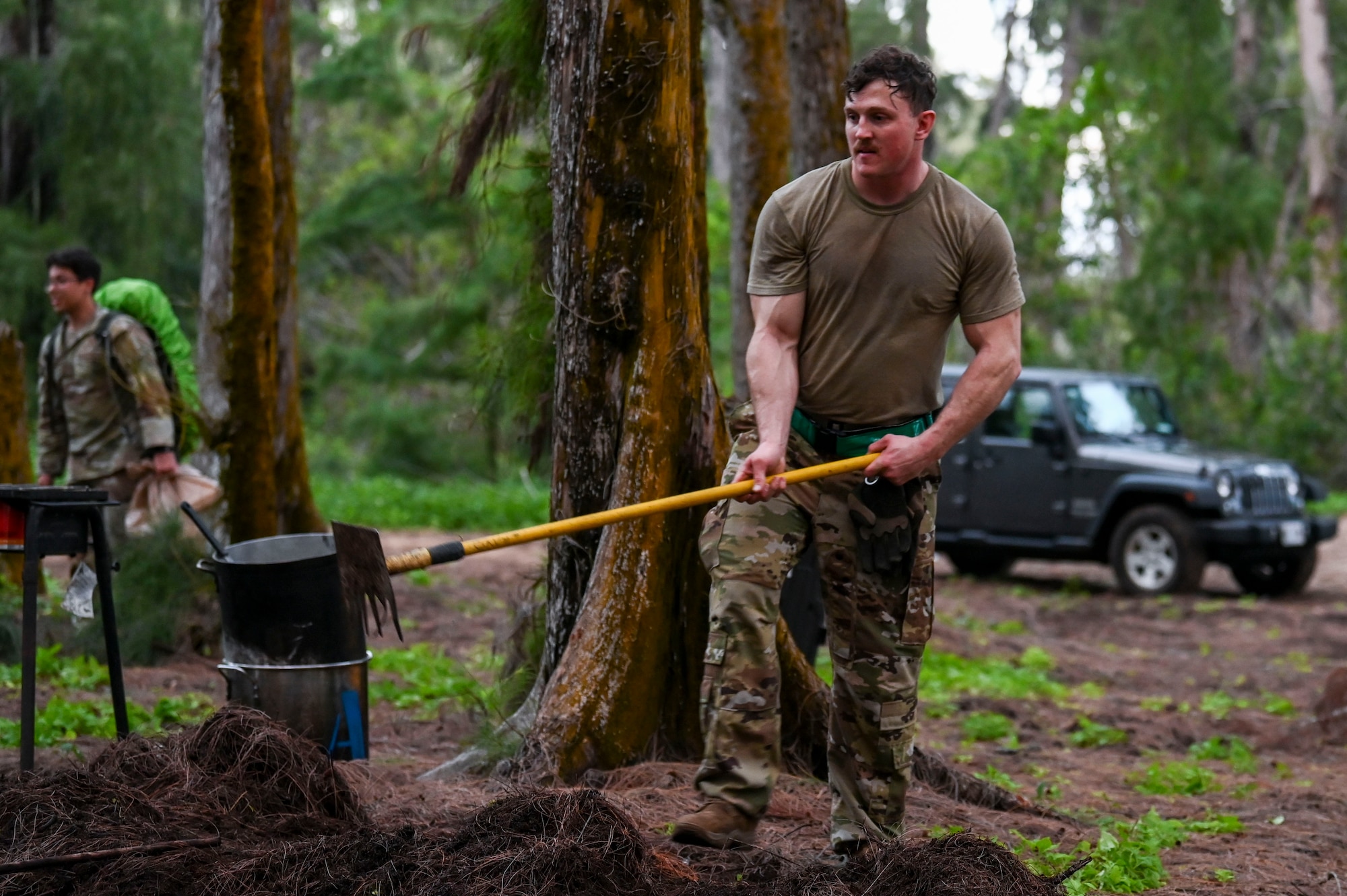 U.S. Air Force Staff Sgt. Daniel Hukill, 92nd Aircraft Maintenance Squadron flying crew chief, plows the ground in preparation to build a shelter at Bellows Air Force Station, Hawaii, Jan. 30, 2023. Members from Team Fairchild’s innovation cell conducted an event to review current foundational survival training methods and their applicability to tropic, jungle, and coastal conditions by taking three groups of members with varying levels of survival training. (U.S. Air Force photo by Airman 1st Class Haiden Morris)
