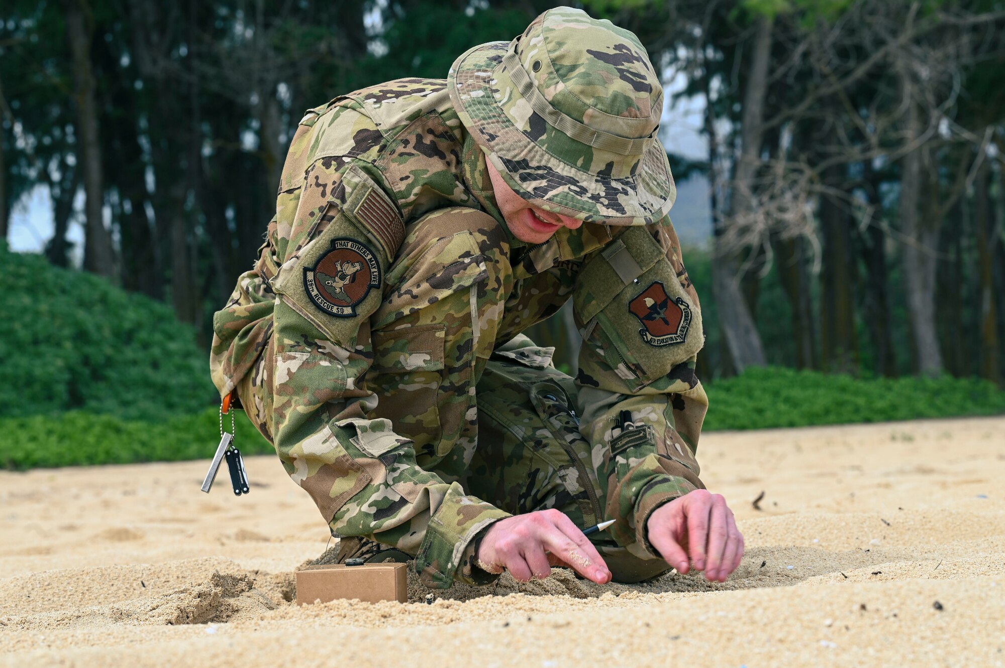 U.S. Air Force 1st Lt. Aaron King, 36th Rescue Squadron pilot, demonstrates his survival skills during a simulated isolation scenario at Bellows Air Force Station, Hawaii, Feb. 1, 2023. Members from Team Fairchild’s innovation cell conducted an event to review current foundational survival training methods and their applicability to tropic, jungle, and coastal conditions. (U.S. Air Force photo by Airman 1st Class Haiden Morris)