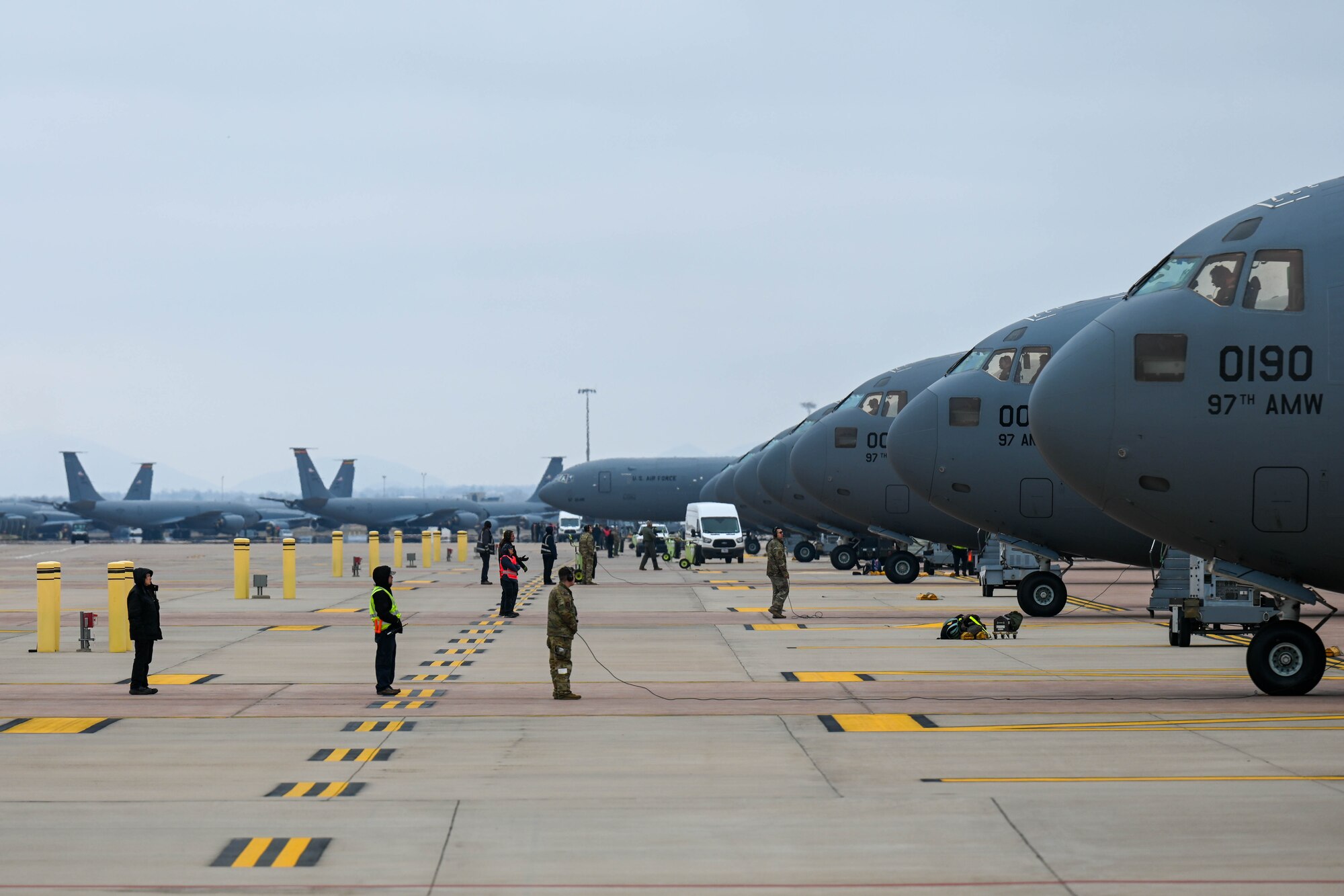 Members of the 97th Aircraft Maintenance Squadron and 58th Airlift Squadron conduct pre-flight checks on C-17 Globemaster IIIs in preparation for a large force exercise at Altus Air Force Base, Oklahoma, March 24, 2023. A total of eight C-17s were generated, launched, and recovered as part of this exercise. (U.S. Air Force photo by Senior Airman Trenton Jancze)