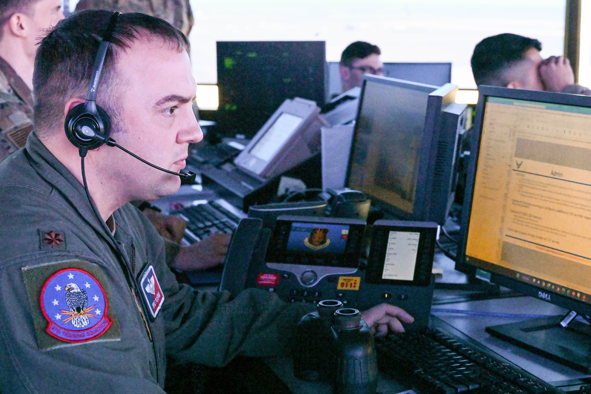 U.S. Air Force Maj. Mike Pickering, 97th Operations Group supervisor of flying, checks flight plans at Altus Air Force Base (AFB), Oklahoma, March 24, 2023. Air traffic control Airmen provide guidance to civilian and military aircraft flying near Altus AFB. (U.S. Air Force photo by Senior Airman Trenton Jancze)