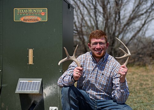 The 17th Civil Engineer Squadron bio-environmentalist Jarrett Louder holds deer antlers at Goodfellow Air Force Base, Texas, March 22, 2023. Louder completed a bachelor's in natural resource management and a master’s in environmental toxicology. (U.S. Air Force photo by Senior Airman Sarah Williams)