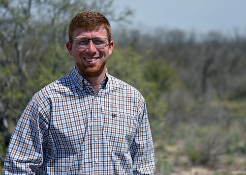 The 17th Civil Engineer Squadron bio-environmentalist Jarrett Louder smiles in San Angelo, Texas, March 22, 2023. Louder oversaw programs pertaining to stormwater runoff, cultural resources, and the deer population on base. (U.S. Air Force photo by Senior Airman Sarah Williams)