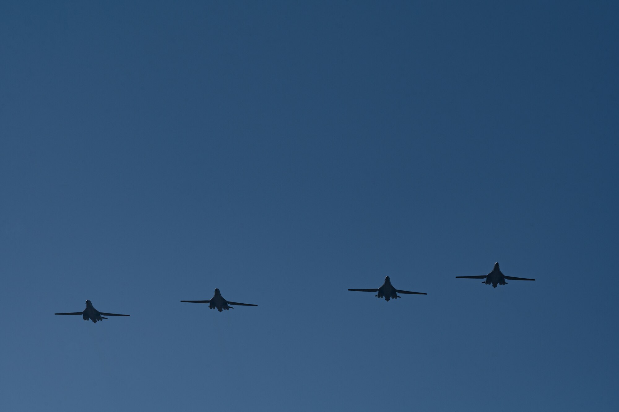 B-1B Lancers fly over the flightline at Dyess Air Force Base, Texas, March 24, 2023. Seven B-1s returned to Dyess after being relocated to Holloman AFB, New Mexico, due to possible major storms. The short-notice aircraft relocation demonstrated the agility of 7th Bomb Wing Airmen while confirming Dyess Strikers are ready to implement agile combat employment on a moment's notice. (U.S. Air Force photo by Airman Emma Anderson)