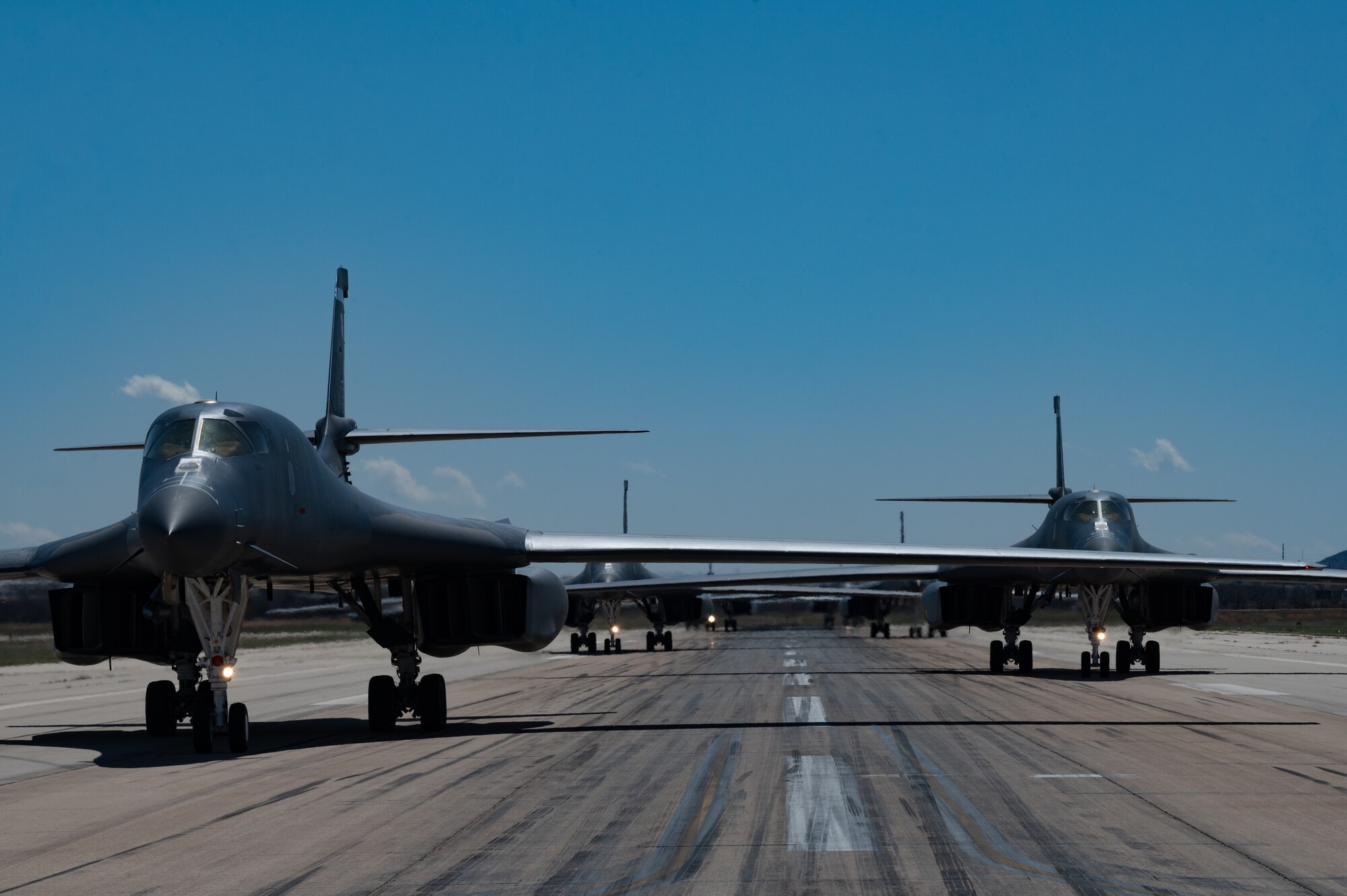 B-1B Lancers taxi onto the flightline at Dyess Air Force Base, Texas, March 24, 2023. Seven B-1s returned to Dyess after being relocated to Holloman AFB, New Mexico, due to possible major storms. The short-notice aircraft relocation demonstrated the agility of 7th Bomb Wing Airmen while confirming Dyess Strikers are ready to implement agile combat employment on a moment's notice. (U.S. Air Force photo by Airman Emma Anderson)