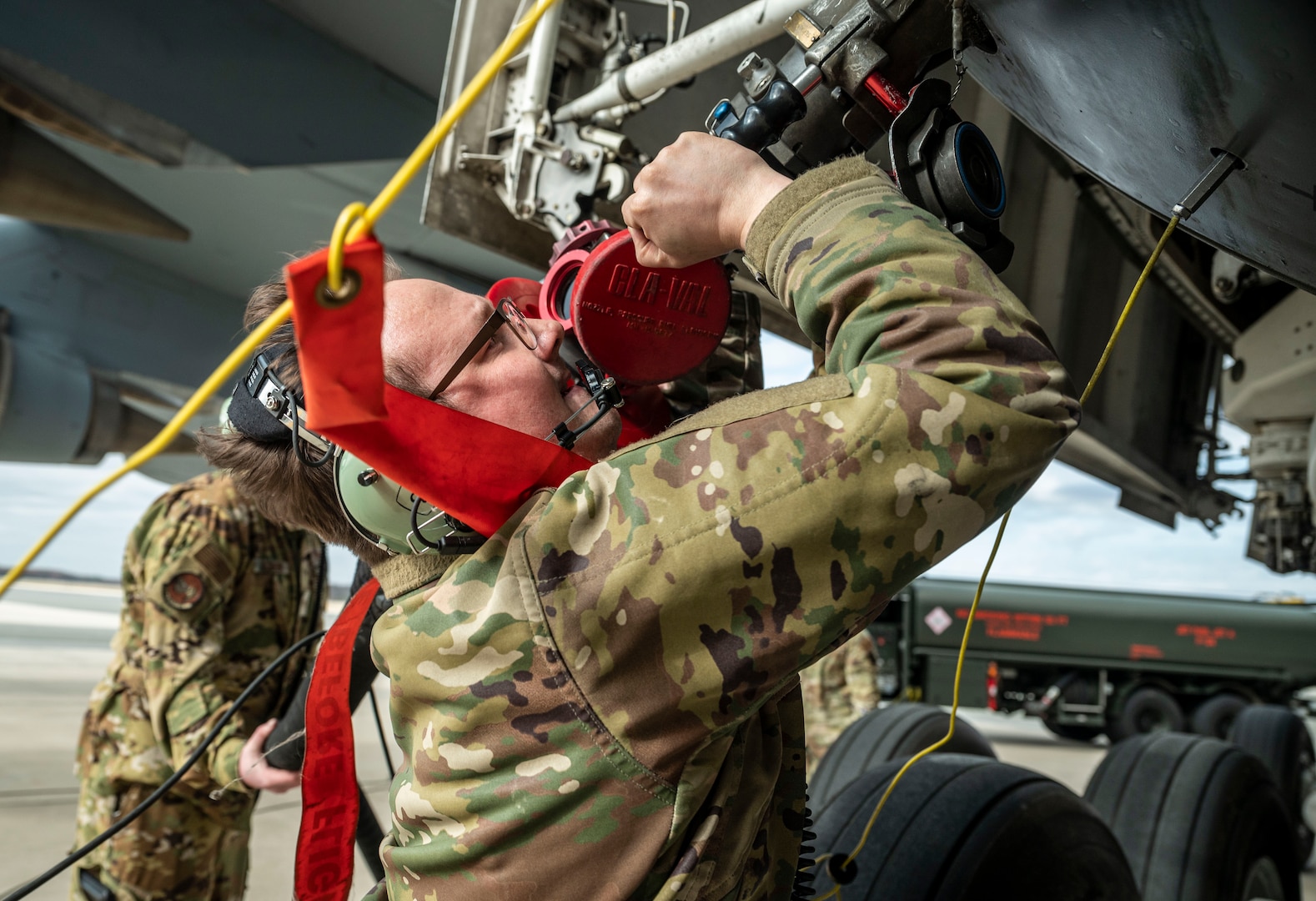 Staff Sgt. Kyle Hewitt, 9th Airlift Squadron flight engineer, attaches a fuel hose from an R-11 Refueler to a C-5M Super Galaxy during a wet wing defuel at Dover Air Force Base, Delaware, March 1, 2023. Aircrew with the 9th AS test out new capabilities that allow the C-5 to act as a mobile fuel station and deposit fuel from the aircraft fuel tanks, into tankers standing by. (U.S. Air Force photo by Staff Sgt. Marco A. Gomez)