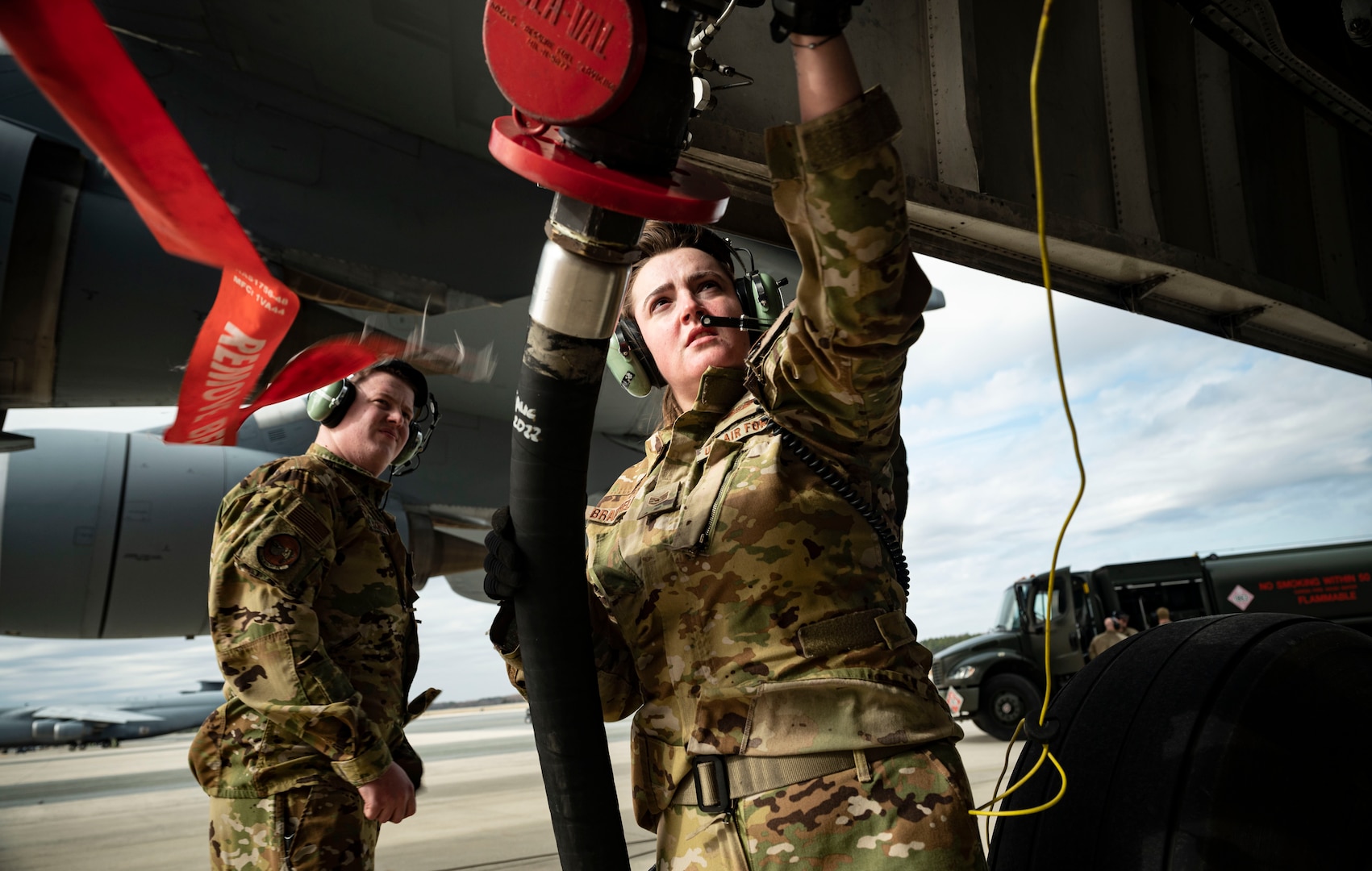 Staff Sgt. Amelia Bradfield, 9th Airlift Squadron loadmaster, secures a fuel hose from an R-11 Refueler onto a C-5M Super Galaxy during a wet wing defuel at Dover Air Force Base, Delaware, March 1, 2023. Aircrew with the 9th AS test out new capabilities that allow the C-5 to act as a mobile fuel station and deposit fuel from the aircraft fuel tanks, into tankers standing by. (U.S. Air Force photo by Staff Sgt. Marco A. Gomez)