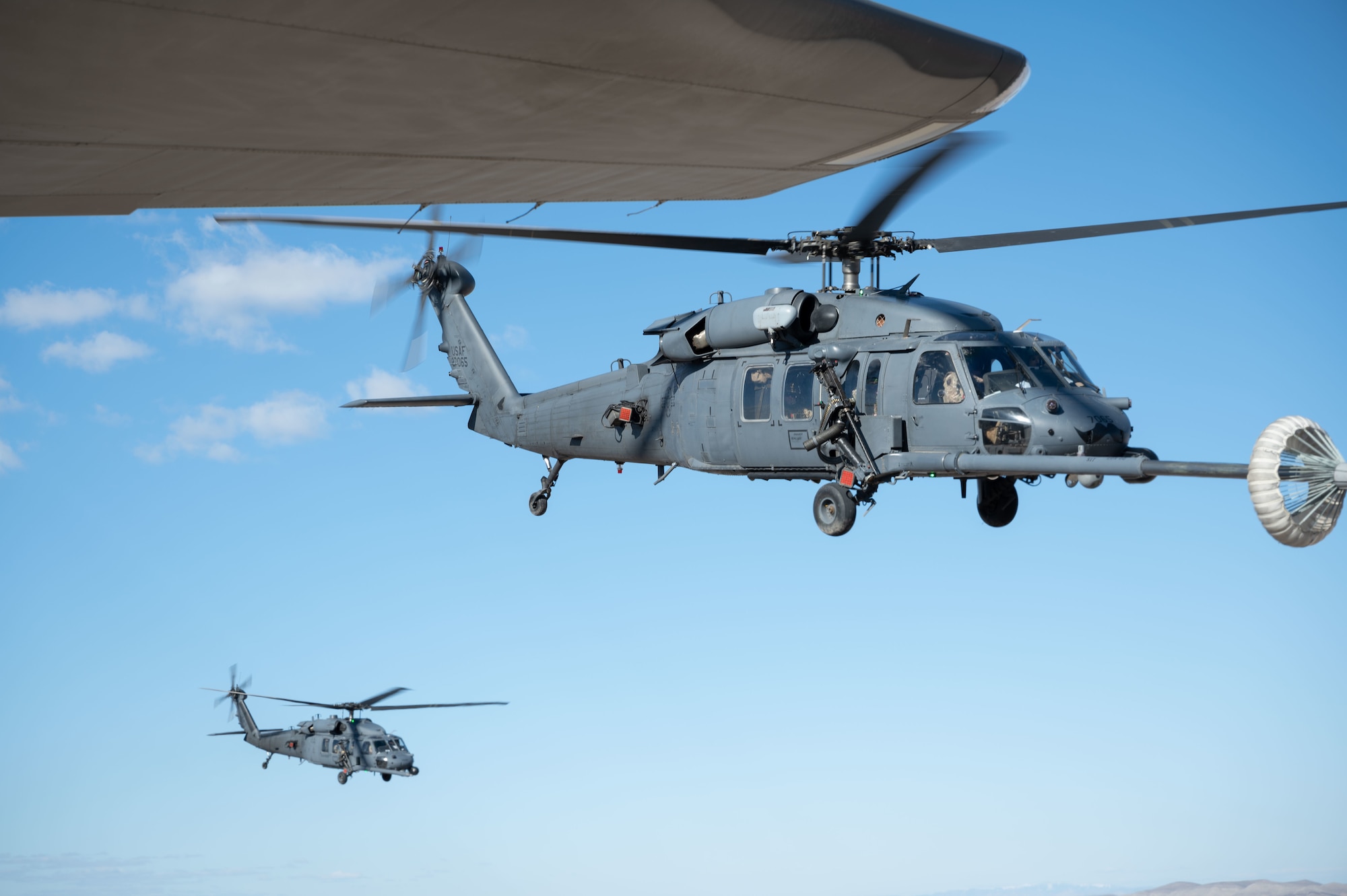 Two HH-60G Pave Hawks engage in midair refueling operations during Red Flag-Nellis 23-2 at Nellis Air Force Base, Nevada, March 16, 2023.