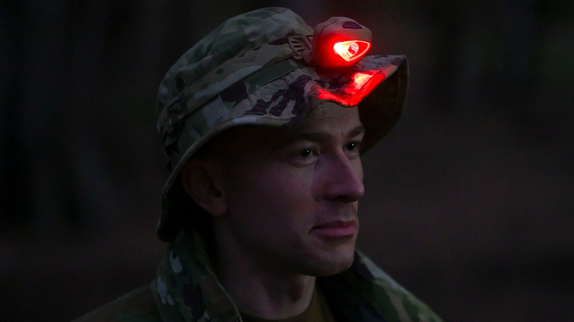 U.S. Air Force 1st Lt. Aaron King, 36th Rescue Squadron pilot, turns on his head lamp at Bellows Air Force Station, Hawaii, Jan. 30, 2023. Members from Team Fairchild’s innovation cell conducted an event to review current foundational survival training methods and their applicability to tropic, jungle, and coastal conditions by taking three groups of members with varying levels of survival training. (U.S. Air Force photo by Airman 1st Class Haiden Morris)