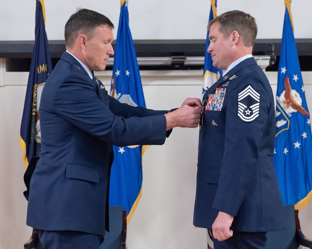 Retired Brig. Gen. Jeffrey Wilkinson, left, former assistant adjutant general for Air in the Kentucky National Guard, presents a Kentucky Distinguished Service Medal to Chief Master Sgt. Karl Grugel, senior enlisted leader for the 123rd Special Tactics Squadron,  during Grugel’s retirement ceremony at the Kentucky Air National Guard Base in Louisville, Ky., Dec. 10, 2022. Grugel served the Air Force and Air National Guard for 31 years. (U.S. Air National Guard photo by Staff Sgt. Clayton Wear)