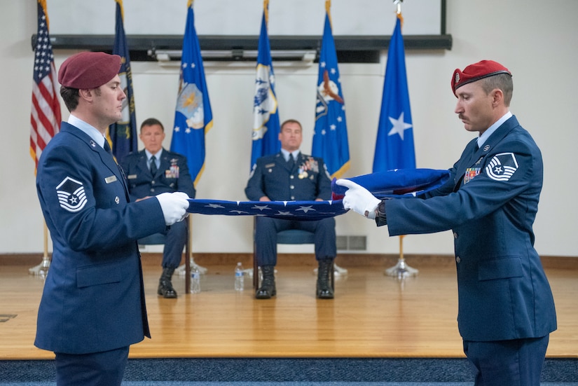 Operators from the 123rd Special Tactics Squadron fold a ceremonial flag for Chief Master Sgt. Karl Grugel, senior enlisted leader of the 123rd Special Tactics Squadron, during his retirement ceremony at the Kentucky Air National Guard Base in Louisville, Ky., Dec. 10, 2022. Grugel served the Air Force and Air National Guard for 31 years. (U.S. Air National Guard photo by Staff Sgt. Clayton Wear)