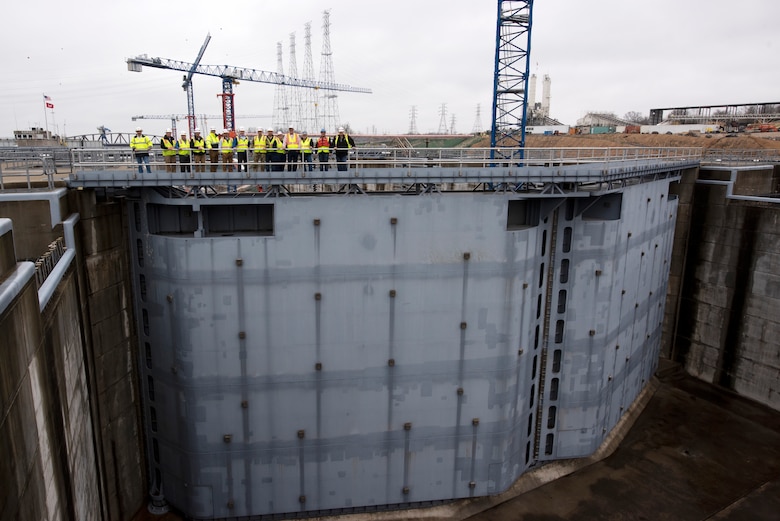 U.S. Army Corps of Engineers Nashville District officials and stakeholders pose for a group photo on top of the miter gates of the completed upstream lock chamber during a tour of the active Kentucky Lock and Kentucky Lock Addition Project on the Tennessee River in Grand Rivers, Kentucky. The Nashville District engaged with stakeholders March 22, 2023, to provide an update on the important navigation project and to promote partnerships and communication. (USACE Photo by Lee Roberts)