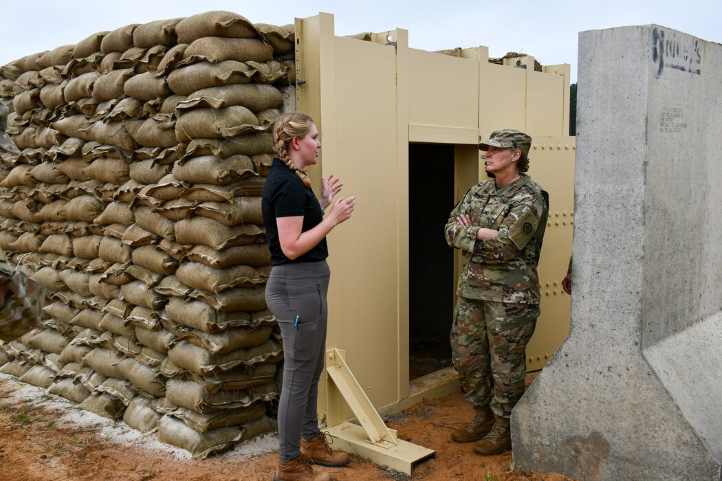 Col. Christina L. Burton, U.S. Army Central engineer director (right), speaks with Jessica Vankirk, U.S. Army Engineer Research and Development Center’s Survivability Engineering Branch research civil engineer (left), about innovative design feature updates on the U.S. Army Central’s Bunker Retrofit project, designed to increase protection for service members throughout the U.S. Central Command’s area of operations, prior to the U.S. Army Engineer Research and Development Center’s Phase II Live-fire Experiment at Fort Polk, La., Mar. 10.
