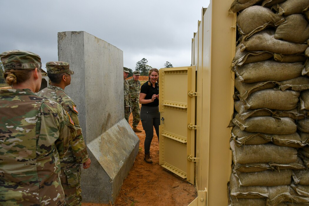 Jessica Vankirk, U.S. Army Corps of Engineers Engineer Research and Development Center’s Survivability Engineering Branch research civil engineer (center), explains innovative design feature updates on the U.S. Army Central’s Bunker Retrofit project, designed to increase protection for service members throughout the U.S. Central Command’s area of operations, prior to the Engineer Research and Development Center’s Phase II Live-fire Experiment at Fort Polk, La., Mar. 10.