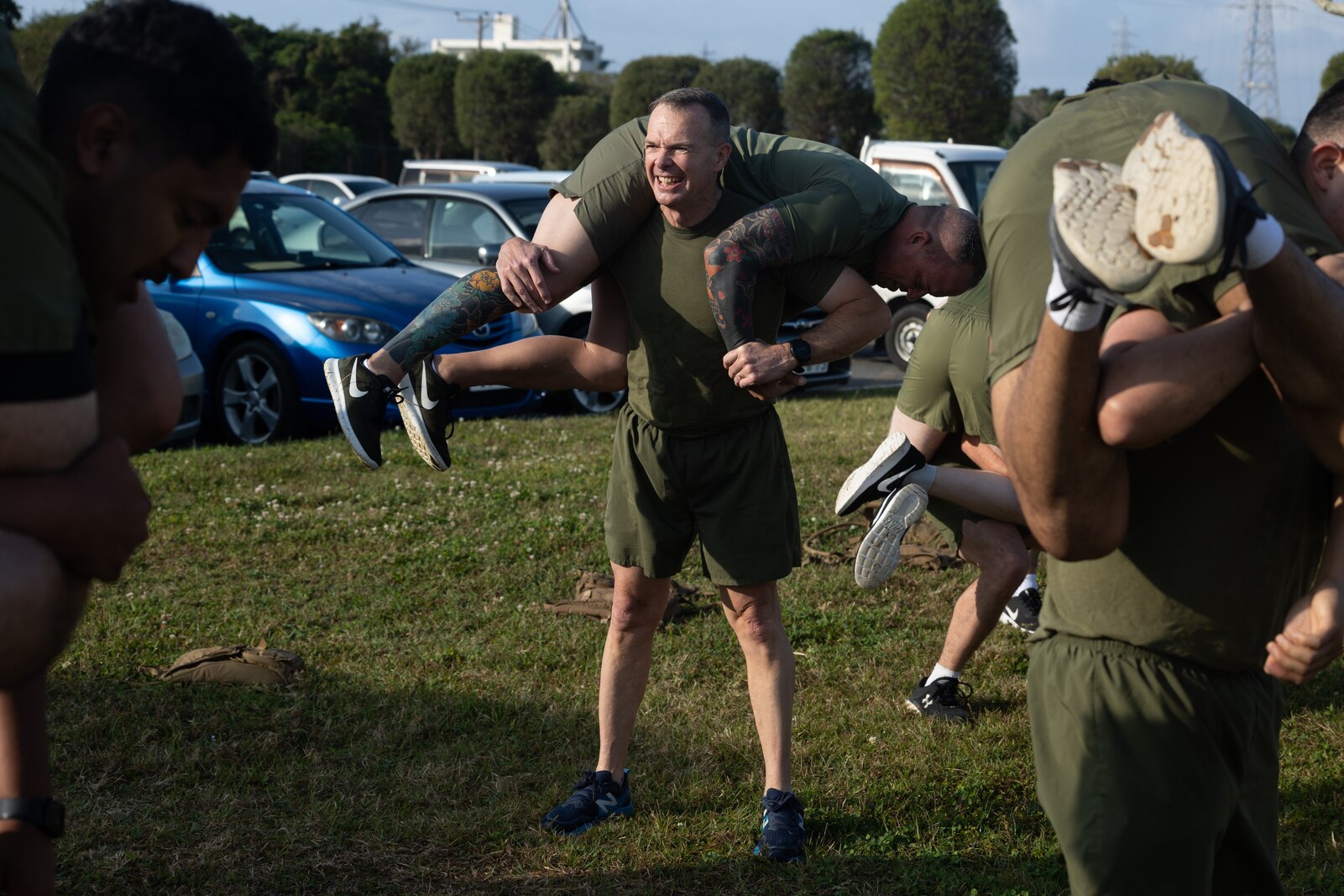 U.S. Marine Corps Maj. Gen. Jay Bargeron, commanding general of 3d Marine Division, and Sgt. Maj. Michael Martinet, sergeant major of 3d Marine Division, participate in a physical training session with non-commissioned officers from 12th Marines commemorating the establishment of the 12th Marines NCO Association on Camp Hansen, Okinawa, Japan, March 17, 2023. (U.S. Marine Corps photo by Lance Cpl. Eduardo Delatorre)