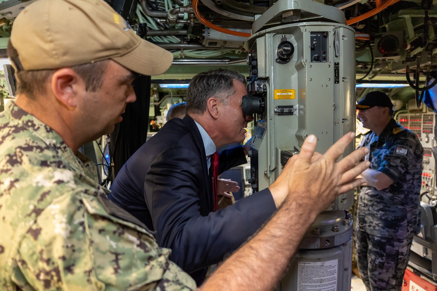HMAS STIRLING, Australia (March 16, 2023) - Australian Deputy Prime Minister Richard Marles looks through the periscope in the control room of the Los Angeles-class fast-attack submarine USS Asheville (SSN 758) during a tour, March 16. Asheville conducted multiple tours for distinguished visitors during a routine port visit to HMAS Stirling, Western Australia to enhance interoperability and communication, and strengthen relationships with the Royal Australian Navy. (Courtesy photo by Australian Department of Defence)
