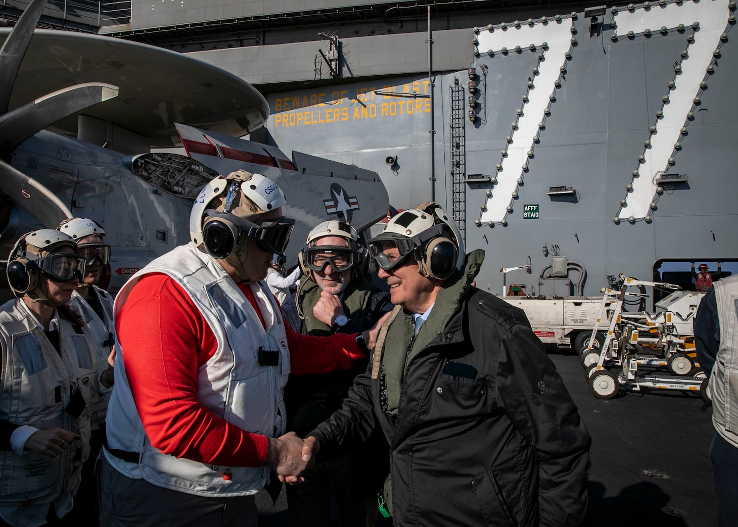 (March 23, 2023) Rear. Adm. Dennis Velez, commander, Carrier Strike Group (CSG) 10, left, welcomes President of the Sicilian Region Renato Schifani, on the flight deck of the Nimitz-class aircraft carrier USS George H.W. Bush (CVN 77), March 23, 2023. The George H.W. Bush CSG is on a scheduled deployment in the U.S. Naval Forces Europe area of operations, employed by U.S. Sixth Fleet to defend U.S., allied and partner interests.