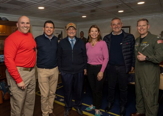 (March 23, 2023)  Rear Adm. Dennis Velez, commander, Carrier Strike Group (CSG) 10, George H.W Bush CSG, left, Gaetano Galvagno, President of the Sicilian Regional Assembly,, second left, President of Sicilian Region Renato Schifani, center left, Tracy Robert-Pounds, Consul General of the United States of America in Naples, center right, Michele Mancuso, Member of the Sicilian Regional Assembly, second right, and Capt. Dave Pollard, commander, Nimitz-class aircraft carrier USS George H.W. Bush (CVN 77), pose for a group photo, March 23, 2023. The George H.W. Bush Carrier Strike Group is on a scheduled deployment in the U.S. Naval Forces Europe area of operations, employed by U.S. Sixth Fleet to defend U.S., allied and partner interests.