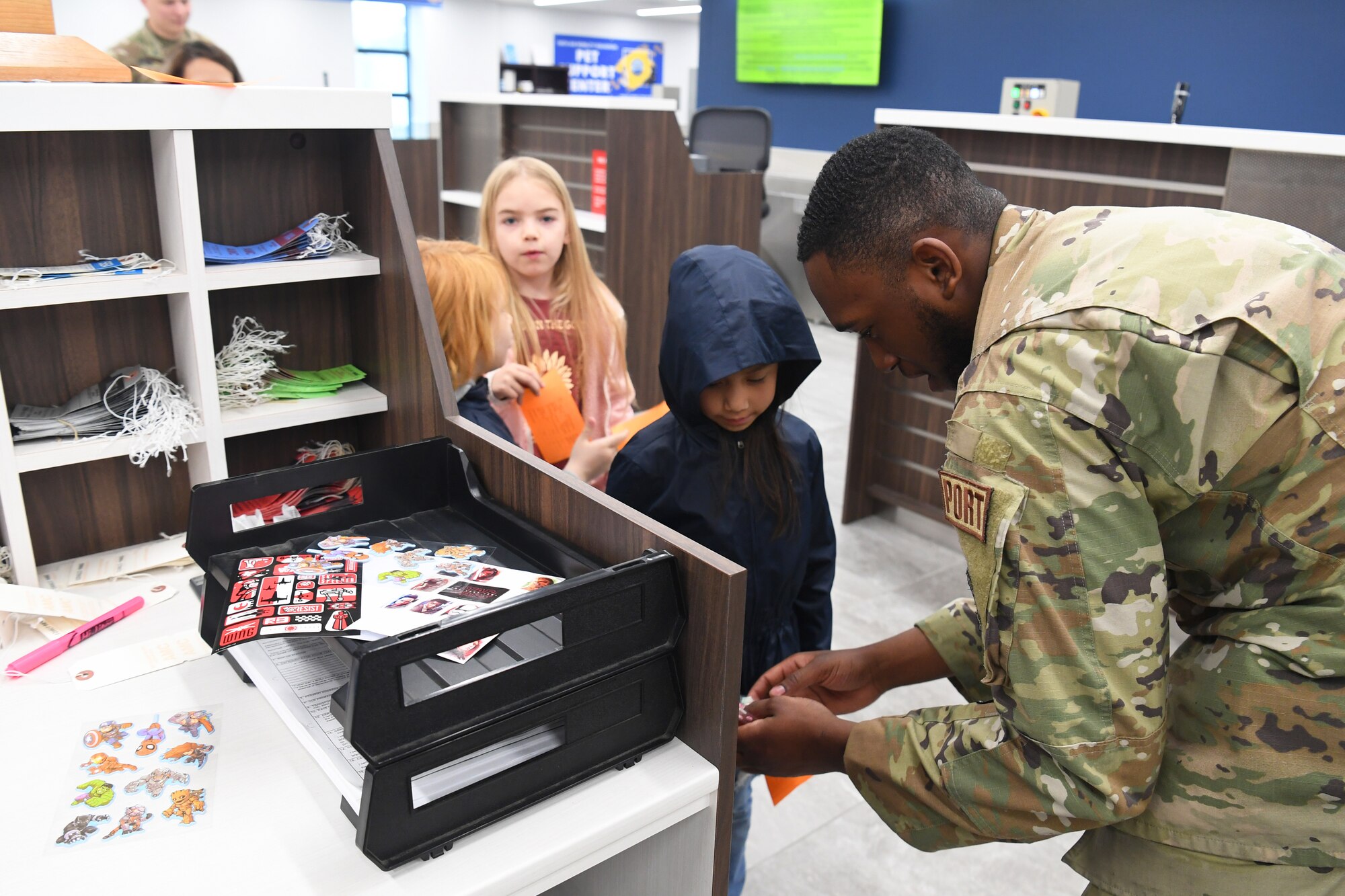 Airman 1st Class Timothy Jones, 730th Air Mobility Squadron passenger services agent, “checks in” students from Yokota West Elementary School on a field trip to the Yokota Passenger Terminal at Yokota Air Base, Japan, March 17, 2023. After receiving stickers on their boarding passes, the kids lined up and filed through the security inspection area to learn about how the 730th AMS ensures safe flights for all of their passengers. (U.S. Air Force photo by Tech. Sgt. Taylor A. Workman)