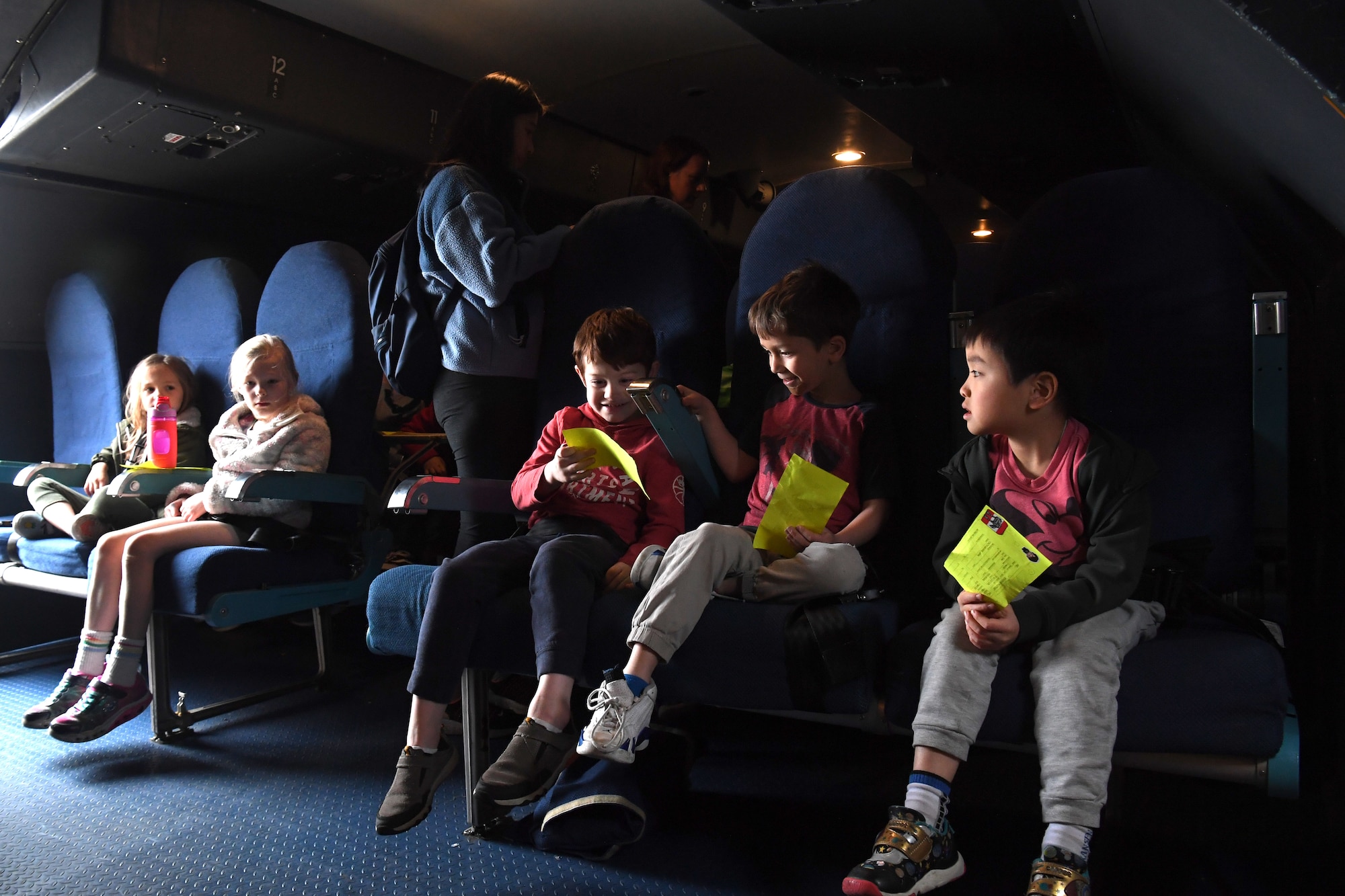 Students from Yokota West Elementary School experience the passenger area of a visiting Air Mobility Command C-5M Super Galaxy during a field trip of the Yokota Passenger Terminal at Yokota Air Base, Japan, March 17, 2023. The kids and their teachers marveled at the size of the air-giant, standing at a massive 20 meters tall with a wingspan of 68 meters. (U.S. Air Force photo by Tech. Sgt. Taylor A. Workman)