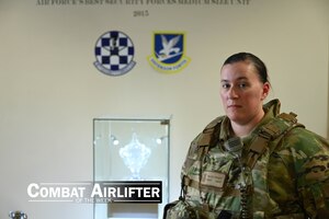 women in uniform poses for a photo
