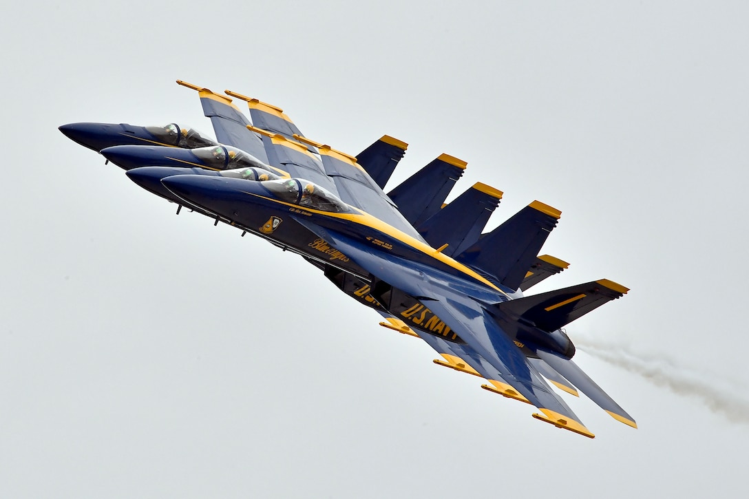 Navy aircraft perform an air maneuver.