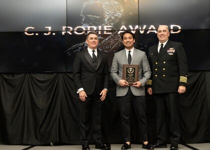 IMAGE: Naval Surface Warfare Center Dahlgren Division (NSWCDD) Technical Director Dale Sisson Jr., SES, and Commanding Officer Capt. Philip Mlynarski presented STG1 Ray Joseph Odviar with the C.J. Rorie Award during the NSWCDD Annual Honorary Awards ceremony at the Fredericksburg Expo Center March 10.