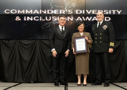 IMAGE: Naval Surface Warfare Center Dahlgren Division (NSWCDD) Technical Director Dale Sisson Jr., SES, and Commanding Officer Capt. Philip Mlynarski presented Tzawe Wang with the Commander’s Diversity and Inclusion Award during the NSWCDD Annual Honorary Awards ceremony at the Fredericksburg Expo Center March 10.